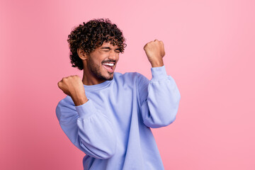 Photo of crazy positive glad man wear blue stylish clothes rejoice victory lottery jackpot luck isolated on pink color background