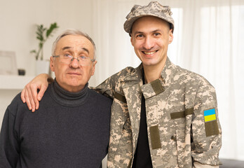 Wall Mural - Soldier in military uniform reunited with his family and Ukrainian flag