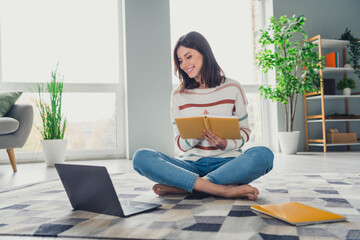 Poster - Full body photo of positive pretty barefoot lady sit carpet floor hold notebook watch video laptop modern flat indoors