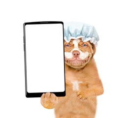 Poster - Smiling Mastiff puppy with shower cap it head holds  big smartphone with white blank screen in it paw. isolated on white background