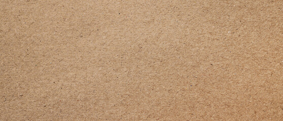 brown kraft paper or cardboard texture, old paper sheet for background, beige rough carton, parchment or papyrus.