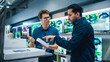 © Gorodenkoff - Young Multiethnic Customer Advising with Retail Home Electronics Store Salesperson. Stylish Man is Interested in Buying a Smartphone. Client Shopping for a New Cellphone in a Modern Shop
