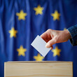 Man putting ballot in box during elections in europe.