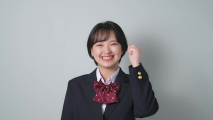 Poster - ガッツポーズする制服を着た女子学生