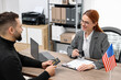 © New Africa - Immigration to United States of America. Embassy worker approving man's visa application form in office