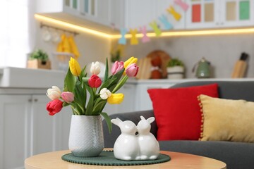 Sticker - Easter decorations. Bouquet of tulips and bunny figures on table indoors