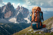A large, washable hiking backpack standing on a stone with mountains in the background. Mountain landscape with a hiking backpack
