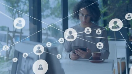 Poster - Animation of network of connections with icons over biracial businessman using tablet