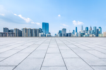 Wall Mural - Empty square pavement and city skyline background