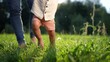 © maxximmm - baby takes first steps in the park. happy family kid dream concept. dad teaches his son to walk takes the first steps in the park on green grass. lifestyle baby son taking first steps