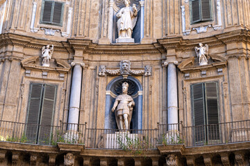 Wall Mural - A statue of a man is on the side of a building