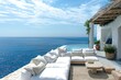 Inviting Mediterranean patio with white modern cushioned lounge, overlooking the azure sea