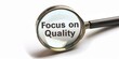 Symbolizing Quality Assurance, Magnifying Glass Focused on Focus on Quality Phrase Against White Background