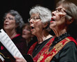 Group of elderly individuals singing in a choir, showcasing the unifying power of music in social activities