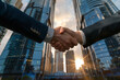 Business handshake on the background of skyscrapers in the city.