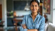 © buraratn - Head shot portrait smart confident smiling millennial indian woman standing with folded arms at home.