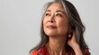 © buraratn - Middle aged happy mature asian woman, senior 55 year lady looking away, isolated on white closeup headshot. Ads of antiaging uv protection whitening menopause dry skincare, plastic surgery.