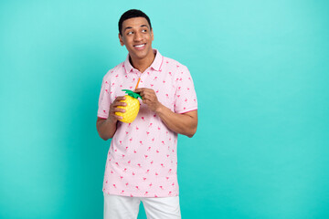 Sticker - Portrait of positive minded guy hold pineapple drink cup straw look empty space isolated on turquoise color background