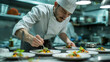 © Santy Hong - Male chef plating food in plate or preparing cooking food in kitchen at restaurant.