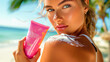 Beautiful young woman applying spf cream on her shoulder on the beach and holding a pink cream tube. taking care of skin to protect from UV rays. Health concept. beautiful, healthy and even tan