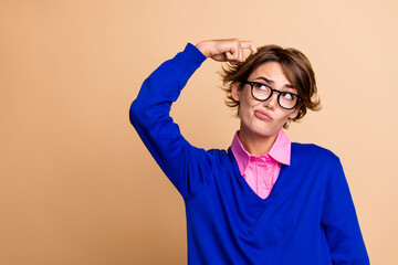 Poster - Photo of minded pensive girl hand finger scratch head look empty space ponder isolated on beige color background