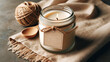 mockup on a glass jar with a handmade candle, set against a coarse textile background