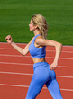 © Yevhen - Woman in sportswear jogging on stadium. Female jogger runner running outdoors, runner. Fitness woman on stadium. Young fitness woman runner running on stadium track