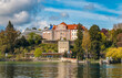 Lovely panoramic view of the medieval Comturey tower and the habour of the famous island Mainau in Lake Constance (Bodensee), Germany. Above are the Teutonic castle with the palm house.