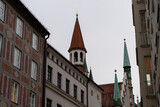 Fototapeta Miasto - A row of buildings with a tall tower in the middle
