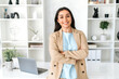 © Kateryna - Female portrait.Cute confident successful young indian or arabian business woman, ceo, hr manager, dressed in elegant suit standing in modern office space with arms crossed, friendly smiling at camera