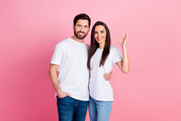 Wall Mural - Photo portrait of lovely young couple hugging okey good quality dressed stylish white garment isolated on pink color background