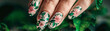Garden party nails, floral patterns, green leaf accents, fresh feel. Glamour woman hand with nail polish on her fingernails. Nail art and design.