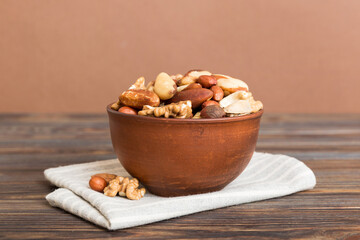 Poster - mixed nuts in bowl. Mix of various nuts on colored background. pistachios, cashews, walnuts, hazelnuts, peanuts and brazil nuts