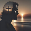 Jesus Christ silhouette with the sunset coast.