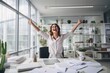 © Iona - Exuberant businesswoman celebrating with arms raised in an office setting, embodying success and achievement