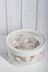 Wall Mural - Marshmallow flowers. Homemade marshmallows. A box with transparent walls and a lid. The box is closed.