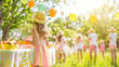 © Neat Design Studio - A group of kids and family celebrating a birthday or Easter in the park at summer