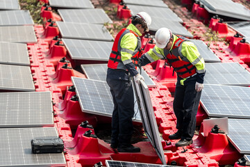 Male workers repair Floating solar panels on water lake. Engineers construct on site Floating solar panels at sun light. clean energy for future living. Industrial Renewable energy of green power.