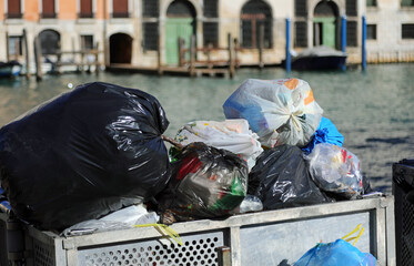 Wall Mural - solid waste garbage bags in an overloaded dumpster in the city