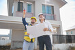 © offsuperphoto - workers or architects holding plan blueprint paper and home inspection at construction site