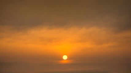 Wall Mural - Painterly sky with sun and clouds at beautiful sunset as natural background