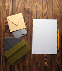 Sticker - Letter, white sheet of paper and envelopes on wooden background