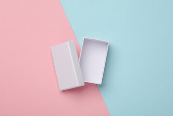 Wall Mural - Open white empty cardboard box on pink blue background