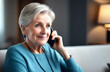 © Anastasija - Beautiful senior woman is talking on the phone. Woman retiree engaged in pleasant talk on phone hold gadget close to ear. Portrait of senior woman at home using mobile phone and technologies.