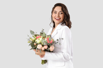 Poster - Beautiful bride with wedding bouquet on light background