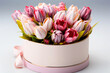 Beautiful bouquet of tulips in a gift box adorned with a ribbon. Perfect for Woman's Day, Mother’s Day, birthday card. Concept of spring, fresh blooms that symbolize renewal and beauty.