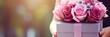 Close up of box with pink and light violet roses in female hands. Banner or gift card for Happy Mother's Day or Happy Women's day, birthday.