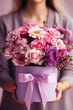 A woman holds a beautiful bouquet in gift box. Concept of thoughtfulness, love and care. Happy Mother's Day or Happy Women's day, birthday card.