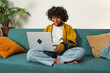 African American girl using laptop at home office typing chatting reading writing email. Young black woman having virtual meeting online chat video call conference. Work learning from home