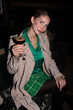 Elegant rich independent Woman in green Dress up with make up in an fancy restaurant and bar over the top berlin